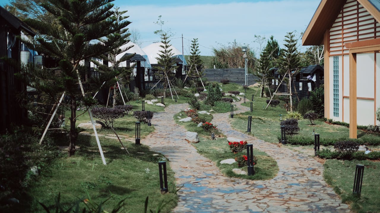 Curved stone garden pathway with decorative boulders and plantings — landscape project, North Ridgeville OH